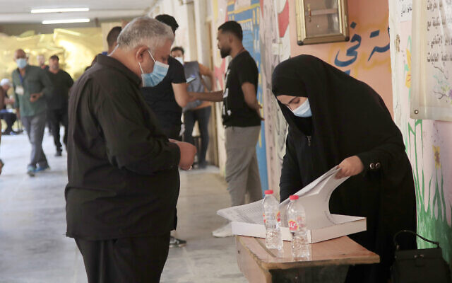 Iraqis voters gather to cast their vote at a ballot station in the country's parliamentary elections in Baghdad, Iraq, October 10, 2021. (AP Photo/Hadi Mizban)