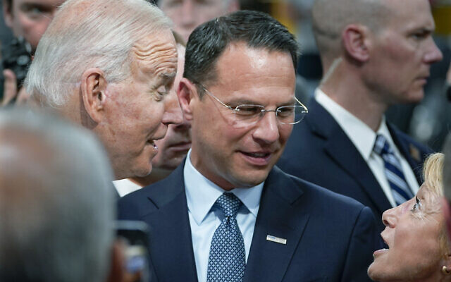 Pennsylvania Attorney General Josh Shapiro, center, and US President Joe Biden talk with people at the Lehigh Valley operations facility for Mack Trucks in Macungie, Pennsylvania, July 28, 2021. (AP Photo/Susan Walsh, File) Pennsylvania Attorney General Josh Shapiro, center, and US President Joe Biden talk with people at the Lehigh Valley operations facility for Mack Trucks in Macungie, Pennsylvania, July 28, 2021. (AP Photo/Susan Walsh, File)