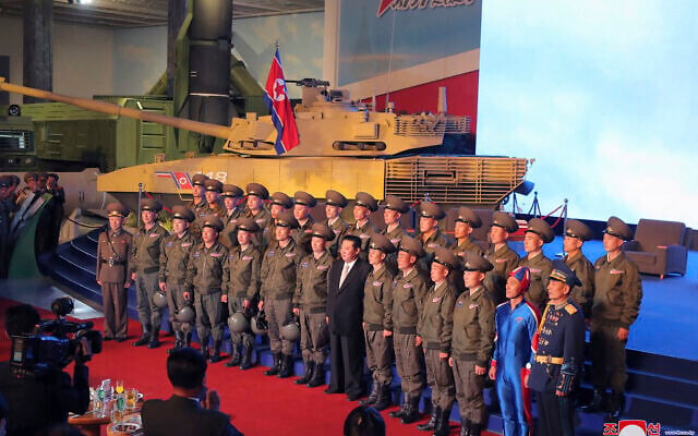 In this photo provided by the North Korean government, North Korean leader Kim Jong Un, center, poses for a group photo with fighter pilots who made the demonstration flight at the opening of an exhibition of weapons systems in Pyongyang, North Korea, Monday, Oct. 11, 2021. (Korean Central News Agency/Korea News Service via AP) In this photo provided by the North Korean government, North Korean leader Kim Jong Un, center, poses for a group photo with fighter pilots who made the demonstration flight at the opening of an exhibition of weapons systems in Pyongyang, North Korea, Monday, Oct. 11, 2021. (Korean Central News Agency/Korea News Service via AP)