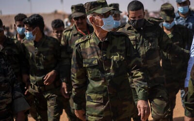 Brahim Ghali, head of the Polisario Front and the self-declared Sahrawi Democratic Arab Republic, center, attends a National Unity Day event in the Dajla refugee camp, Algeria, Tuesday, Oct. 12, 2021. (AP Photo/Bernat Armangue)