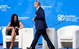 Russian President Vladimir Putin walks past CNBC's anchor Hadley Gamble during the plenary session of the Russian Energy Week in Moscow, Russia, October 13, 2021. (Sergei Ilnitsky/Pool Photo via AP)