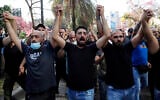 Supporters of the Shiite Hezbollah and Amal groups chant slogans against Judge Tarek Bitar who is investigating last year's deadly seaport blast, during a protest in front of the Justice Palace in Beirut, Lebanon, on Thursday, October 14, 2021. (AP Photo/Hussein Malla)