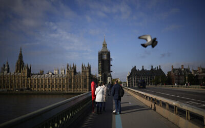 The scaffolded Elizabeth Tower, known as Big Ben, and the Houses of Parliament are seen from Westminster Bridge, in London, Thursday, Oct. 14, 2021. (AP Photo/Matt Dunham)