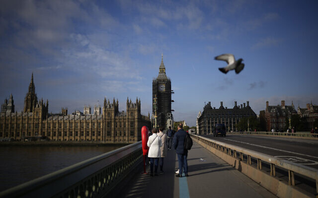 The scaffolded Elizabeth Tower, known as Big Ben, and the Houses of Parliament are seen from Westminster Bridge, in London, Thursday, Oct. 14, 2021. (AP Photo/Matt Dunham)