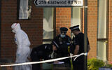 Police officers talk at the scene outside the Belfairs Methodist Church in Eastwood Road North, where British Conservative lawmaker David Amess has died after being stabbed at a constituency surgery, in Leigh-on-Sea, Essex, England, Friday, Oct. 15, 2021. (AP/Alberto Pezzali)