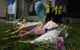 Floral tributes are placed on one of the roads leading to the Belfairs Methodist Church in Eastwood Road North, where British Conservative lawmaker David Amess has died after being stabbed at a constituency surgery, in Leigh-on-Sea, Essex, England, Friday, Oct. 15, 2021. (AP Photo/Kirsty Wigglesworth)