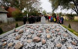 Jewish and Christian clergy stand together for prayers for the souls of some 60 Jews murdered by the occupying Nazi German forces during a ceremony marking a memorial to the victims in Wojslawice, Poland, October 14, 2021. (AP Photo/Czarek Sokolowski)