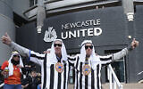 Newcastle fans pose for a photo outside the ground before an English Premier League soccer match between Newcastle and Tottenham Hotspur at St. James' Park in Newcastle, England, on October 17, 2021. (AP Photo/Jon Super)