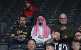Newcastle fans wait for the start of an English Premier League soccer match between Newcastle and Tottenham Hotspur at St. James' Park in Newcastle, England, Sunday Oct. 17, 2021. (AP Photo/Jon Super)