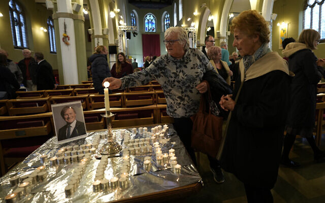 Candles are lit next to a portrait of British Lawmaker David Amess during a vigil for him at St Michaels Church, in Leigh-on-Sea, England, Sunday, Oct. 17, 2021. Amess was killed on Friday during a meeting with constituents at Belfairs Methodist church, in Leigh-on-Sea, Essex, England. (AP Photo/Alastair Grant) Candles are lit next to a portrait of British Lawmaker David Amess during a vigil for him at St Michaels Church, in Leigh-on-Sea, England, Sunday, Oct. 17, 2021. Amess was killed on Friday during a meeting with constituents at Belfairs Methodist church, in Leigh-on-Sea, Essex, England. (AP Photo/Alastair Grant)