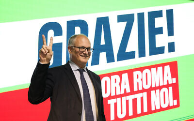 Center-left mayoral candidate Roberto Gualtieri flashes a v-sign at his party's headquarters in Rome, October 18, 2021. (Gregorio Borgia/AP)