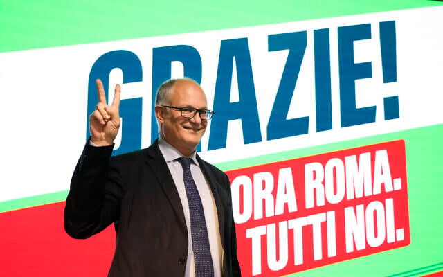 Center-left mayoral candidate Roberto Gualtieri flashes a v-sign at his party's headquarters in Rome, October 18, 2021. (Gregorio Borgia/AP) Center-left mayoral candidate Roberto Gualtieri flashes a v-sign at his party's headquarters in Rome, October 18, 2021. (Gregorio Borgia/AP)