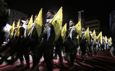 Illustrative: In this May 31, 2019 file photo, Hezbollah fighters march at a rally to mark Jerusalem Day or Al-Quds Day, in the southern Beirut suburb of Dahiyeh, Lebanon. (AP Photo/Hassan Ammar, File)