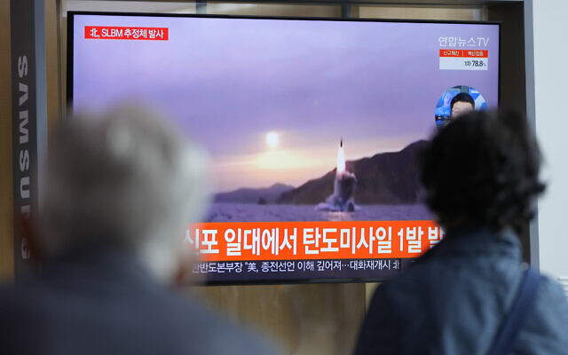 People watch a TV screen showing a news program reporting about North Korea's missile launch with file footage at a train station in Seoul, South Korea, October 19, 2021. (Lee Jin-man/AP) People watch a TV screen showing a news program reporting about North Korea's missile launch with file footage at a train station in Seoul, South Korea, October 19, 2021. (Lee Jin-man/AP)