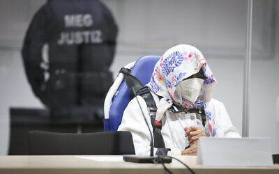 The 96-year-old defendant Irmgard F. sits in an ambulance chair behind a plexiglass screen in a courtroom in Itzehoe, Germany, Oct. 19, 2021 (Christian Charisius/DPA via AP, Pool)