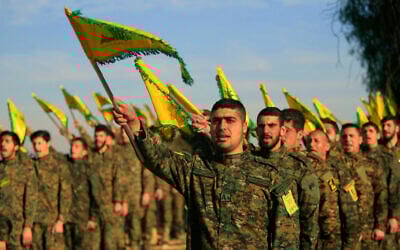 Illustrative: Hezbollah fighters hold flags as they attend the memorial of their slain leader Sheik Abbas al-Mousawi, who was killed by an Israeli airstrike in 1992, in Tefahta village, South Lebanon, February 13, 2016. (AP Photo/Mohammed Zaatari, File)