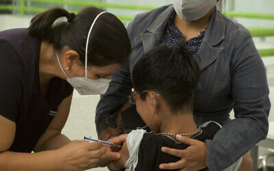 Illustrative -- A healthcare worker injects a boy with a dose of the Pfizer COVID-19 vaccine, during a vaccination drive for children between the ages of 12-17, in Tuxtla Gutierrez, Mexico, Oct. 20, 2021. (AP Photo/Isabel Mateos)