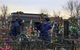 Gravediggers carry a coffin with a body of a patient who died of coronavirus at the Novo-Yuzhnoye cemetery, which serves as one of the burial grounds for those who died of the coronavirus outside Omsk, Russia, Oct. 22, 2021 (AP Photo)