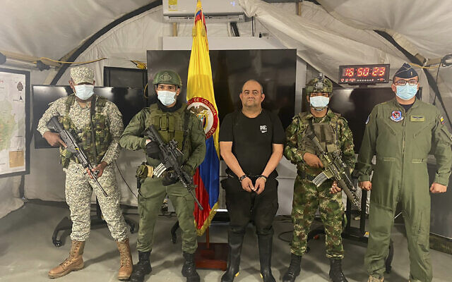 In this photo released by the Colombian presidential press office, one of the country’s most wanted drug traffickers, Dairo Antonio Usuga, alias “Otoniel,” leader of the violent Clan del Golfo cartel, is presented to the media at a military base in Necocli, Colombia, October 23, 2021. (Colombian presidential press office via AP) In this photo released by the Colombian presidential press office, one of the country’s most wanted drug traffickers, Dairo Antonio Usuga, alias “Otoniel,” leader of the violent Clan del Golfo cartel, is presented to the media at a military base in Necocli, Colombia, October 23, 2021. (Colombian presidential press office via AP)