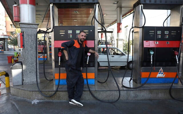 A worker leans against a gasoline pump that has been turned off, at a gas station in Tehran, Iran, Tuesday, Oct. 26, 2021. (AP Photo/Vahid Salemi) A worker leans against a gasoline pump that has been turned off, at a gas station in Tehran, Iran, Tuesday, Oct. 26, 2021. (AP Photo/Vahid Salemi)