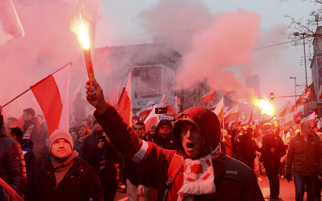 In this file photo from November 11, 2018   marchers burn flares during the annual March of Independence organized by far right activists to celebrate 100 years of Poland's independence marking the nation regaining its sovereignty at the end of World War I after being wiped off the map for more than a century. (AP Photo/Alik Keplicz, File)