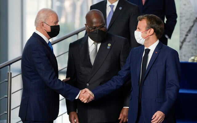US President Joe Biden greets French President Emmanuel Macron (right), as Democratic Republic of Congo's President and African Union Chair Felix Tshisekedi looks on prior to a group photo of world leaders at the La Nuvola conference center for the G20 summit in Rome, on October 30, 2021. (AP Photo/Gregorio Borgia) US President Joe Biden greets French President Emmanuel Macron (right), as Democratic Republic of Congo's President and African Union Chair Felix Tshisekedi looks on prior to a group photo of world leaders at the La Nuvola conference center for the G20 summit in Rome, on October 30, 2021. (AP Photo/Gregorio Borgia)