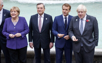 From left, German Chancellor Angela Merkel, Italian Premier Mario Draghi, French President Emmanuel Macron and British Prime Minister Boris Johnson stand at the Trevi Fountain during an event for the G20 summit in Rome, October 31, 2021. (Roberto Monaldo/LaPresse via AP)