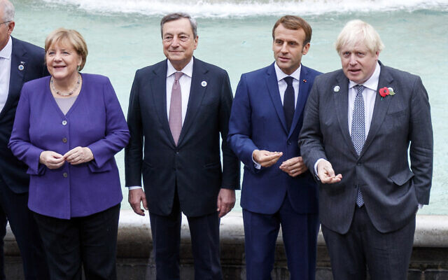 From left, German Chancellor Angela Merkel, Italian Premier Mario Draghi, French President Emmanuel Macron and British Prime Minister Boris Johnson stand at the Trevi Fountain during an event for the G20 summit in Rome, October 31, 2021. (Roberto Monaldo/LaPresse via AP) From left, German Chancellor Angela Merkel, Italian Premier Mario Draghi, French President Emmanuel Macron and British Prime Minister Boris Johnson stand at the Trevi Fountain during an event for the G20 summit in Rome, October 31, 2021. (Roberto Monaldo/LaPresse via AP)