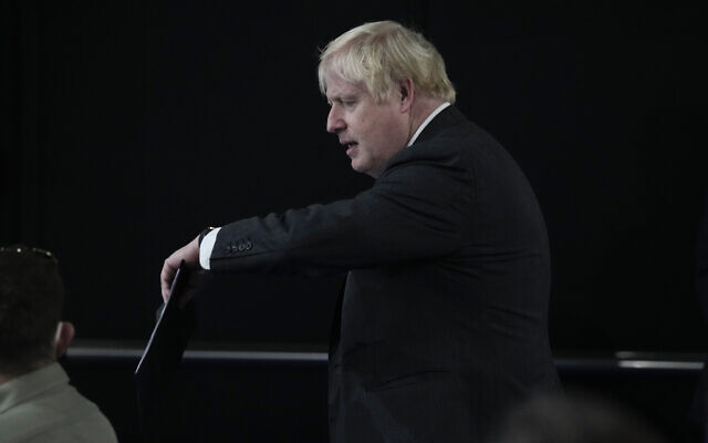 British Prime Minister Boris Johnson arrives for a press conference at the La Nuvola conference center for the G20 summit in Rome, October 31, 2021. (AP Photo/Kirsty Wigglesworth)