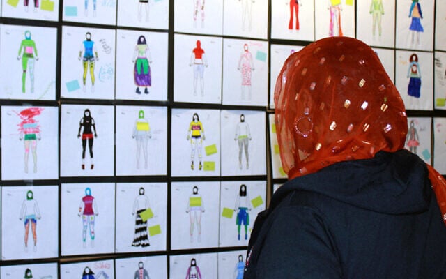 Illustrative: In this June 10, 2015 photo, a girls looks at design drawings for Muslim girls' athletic wear before a fashion show in Minneapolis. (AP/Jeff Baenen) Illustrative: In this June 10, 2015 photo, a girls looks at design drawings for Muslim girls' athletic wear before a fashion show in Minneapolis. (AP/Jeff Baenen)