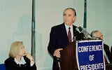 Then-consul general to New York Colette Avital looks on as then-foreign minister Shimon Peres addresses the Conference of Presidents of Major Jewish Organizations, on May 23, 1994, in New York. (AP Photo/David Karp)