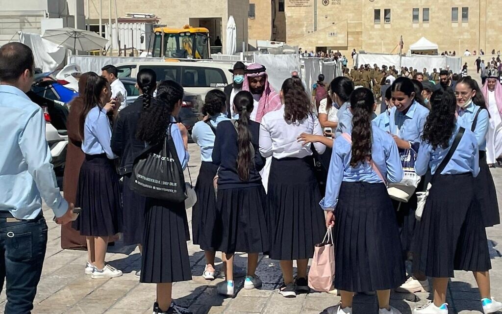 Bahraini acitvist Mohamed Al Shaer speaks with Haredi schoolgirls in the Old City of Jerusalem, October 6, 2021 (Lazar Berman, Times of Israel)