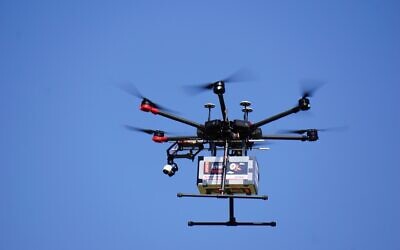 A drone flies near the city of Tel Aviv on October 11, 2021, in a pilot run by the Israel Innovation Authority with partners to create a network of drone deliveries in Israel (Emanuel Fabian/Times of Israel)