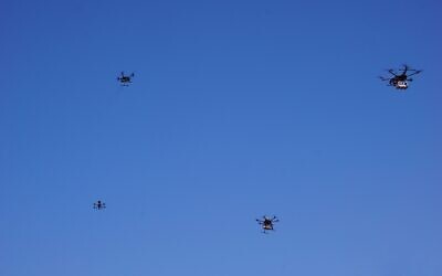 Drones flying near the city of Tel Aviv on October 11, 2021, in a pilot run by the Israel Innovation Authority with partners to create a network of drone deliveries in Israel. (Emanuel Fabian/Times of Israel)