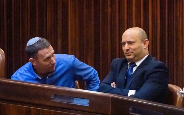 Yamina's Naftali Bennett (R) and MK Matan Kahana in the Knesset on June 2, 2021. (Olivier Fitoussi/Flash90) Yamina's Naftali Bennett (R) and MK Matan Kahana in the Knesset on June 2, 2021. (Olivier Fitoussi/Flash90)