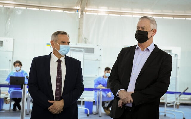 Defense Minister Benny Gantz (right) and Health Minister Nitzan Horowitz visit a COVID-19 testing facility at Ben Gurion Airport, on July 12, 2021. (Flash90) Defense Minister Benny Gantz (right) and Health Minister Nitzan Horowitz visit a COVID-19 testing facility at Ben Gurion Airport, on July 12, 2021. (Flash90)