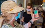 People present proof of vaccination at the entrance to a Jerusalem bakery on August 8, 2021. (Olivier Fitoussi/Flash90)