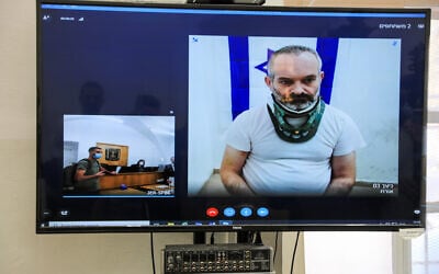 Guy Shapiro, suspected of murdering of his wife in Ma'ale Adumim the month before, is seen on a screen via a video link during a remand  hearing at the Jerusalem Magistrate's Court, October 7, 2021. (Olivier Fitoussi/Flash90)