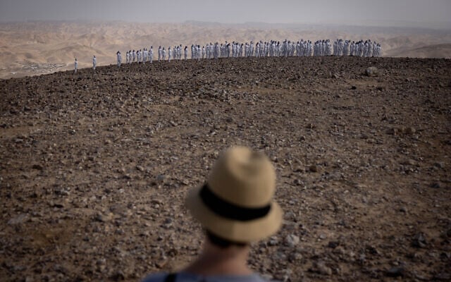 A few hundred naked people covered in white paint pose for a group picture taken by Spencer Tunick, outside Arad in southern Israel, October 17, 2021. (Yonatan Sindel/Flash90)