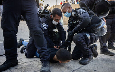 Police arrest a Palestinian youth outside Damascus Gate near Jerusalem's Old City, on October 20, 2021. (Yonatan Sindel/Flash90)