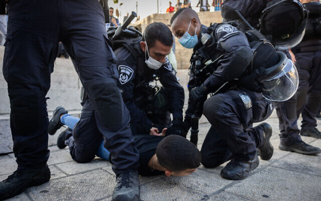 Police arrest a Palestinian youth outside Damascus Gate near Jerusalem's Old City, on October 20, 2021. (Yonatan Sindel/Flash90) Police arrest a Palestinian youth outside Damascus Gate near Jerusalem's Old City, on October 20, 2021. (Yonatan Sindel/Flash90)