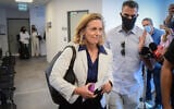 Dr. Sharon Alroy-Preis, head of public health services, is accompanied by a security guard as she walks out of a hearing at the Tel Aviv Magistrates' Court, on October 31, 2021. (Avshalom Sassoni/Flash90)