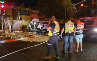 First responders at the scene of a car explosion in the northern coastal city of Nahariya, on October 21, 2021, in which two people were seriously hurt. (Magen David Adom)