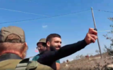 Screen capture from video of a man pepper-spraying volunteers helping Palestinian olive farmers, October 25, 2021. (Rabbis for Human Rights)