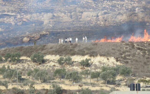 Israeli settlers clash with Palestinians near the West Bank town of Burin on Saturday, on October 16, 2021. (Yesh Din) Israeli settlers clash with Palestinians near the West Bank town of Burin on Saturday, on October 16, 2021. (Yesh Din)