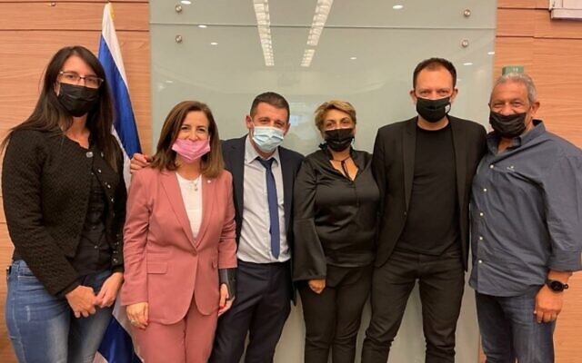 Coalition MKs Yael Ron, Ghaida Rinawie Zoabi, Alex Kushnir, Nira Shpak, Vladimir Beliak and Meir Yitzhak Halevi pose for a photo after advancing the government's budget proposal through the Knesset's Finance Committtee on October 28, 2021. (Knesset Spokesperson's Office) Coalition MKs Yael Ron, Ghaida Rinawie Zoabi, Alex Kushnir, Nira Shpak, Vladimir Beliak and Meir Yitzhak Halevi pose for a photo after advancing the government's budget proposal through the Knesset's Finance Committtee on October 28, 2021. (Knesset Spokesperson's Office)