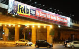 Cars travel under a bridge criticizing Congolese President Felix Tshisekedi in Jerusalem on October 26, 2021. (Courtesy of organizers via JTA)