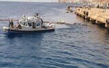 An Israel Navy ship operates off the coast of Eilat after an oil spill, on October 14, 2021. (Eli Warburg and Oz Goren/Environmental Protection Ministry)