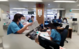 Hospital staff at Hillel Yaffe Medical Center log patient details with pen and paper, following a ransomware cyberattack, October 13, 2021. (Hillel Yaffe Medical Center)