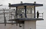 Illustrative: A police officer keeps watch from an observation tower at the Gilboa Prison in northern Israel on September 6, 2021. (Jalaa Marey / AFP)